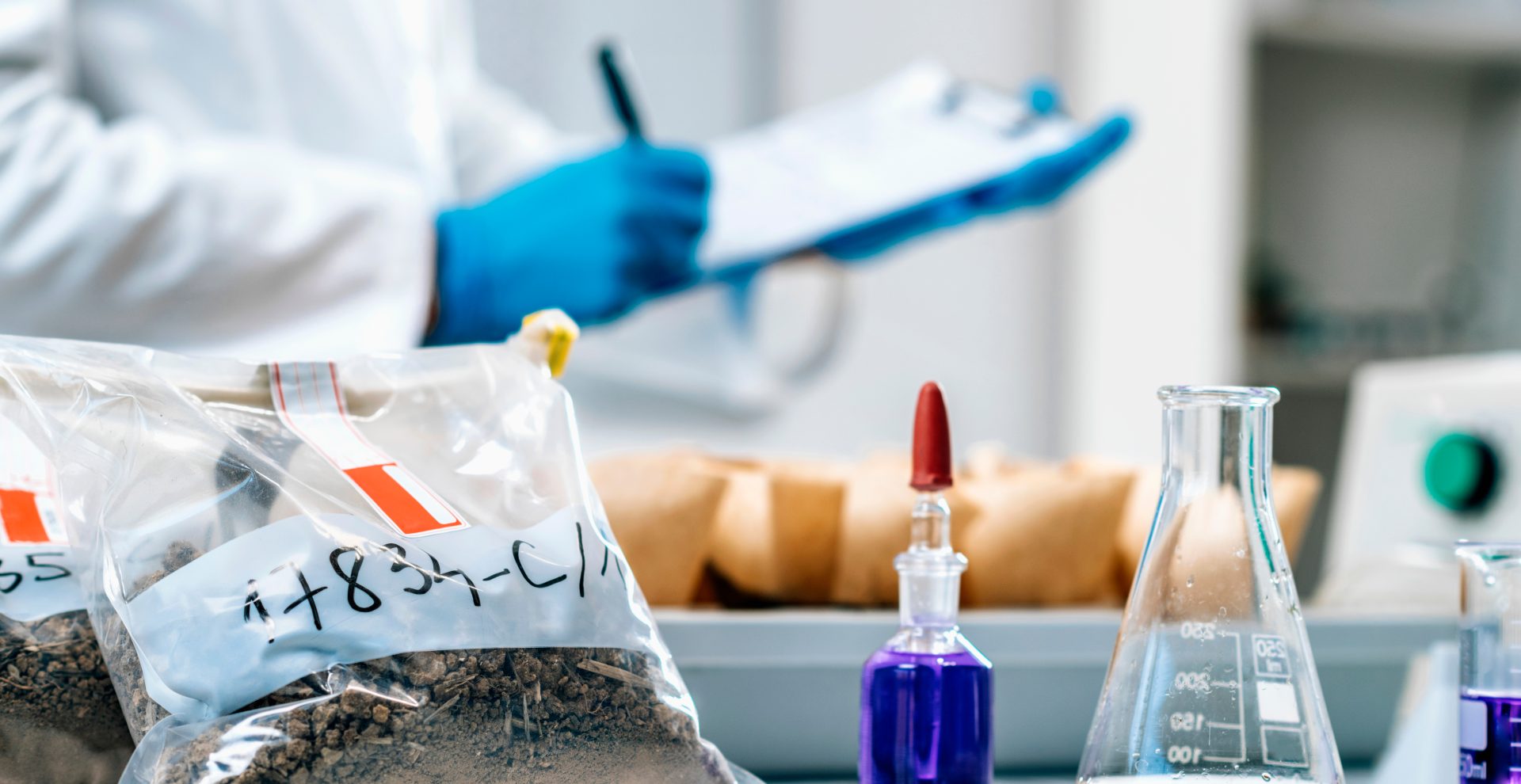 Scientist examining a bag of soil sample in the lab