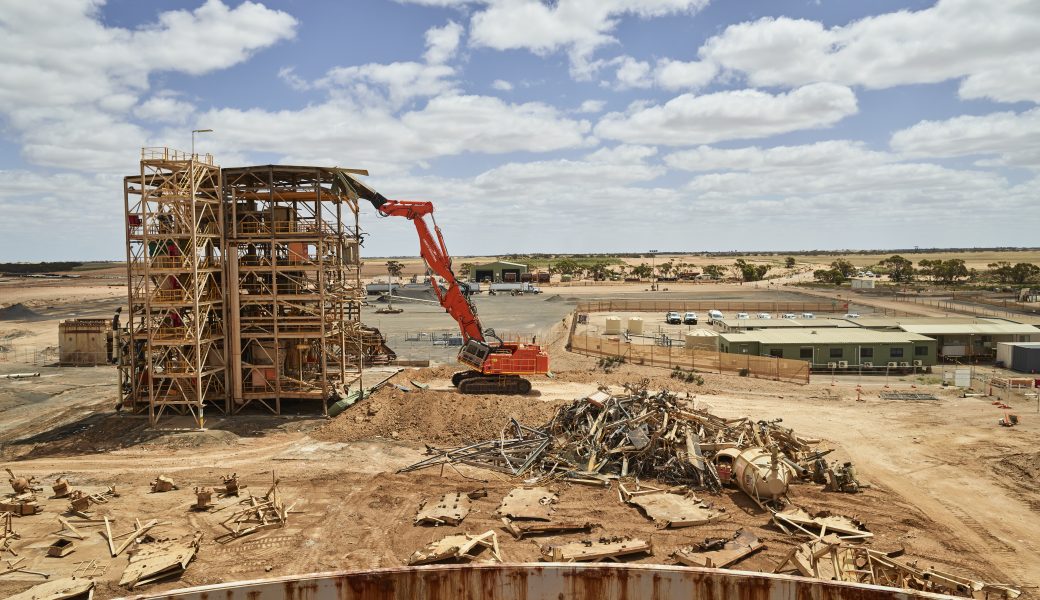 Rig beside a pile of scraps demolishing the process plant